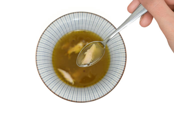 Hot broth with chicken meat in a bowl