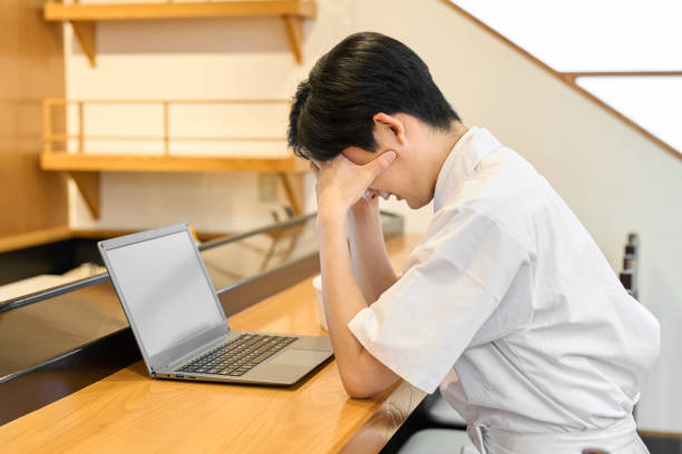 istock A Japanese chef struggling in front of a computer 2199755157