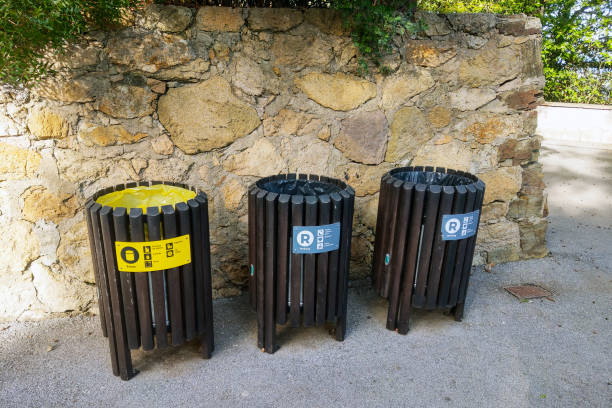 istock Outdoor Recycling Bins by Stone Wall in Sunlit Park Setting for Environmental Awareness 2199757984