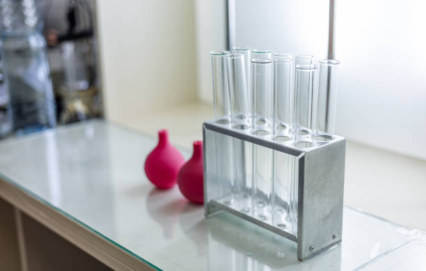 test tubes with red liquid in laboratory on blue background