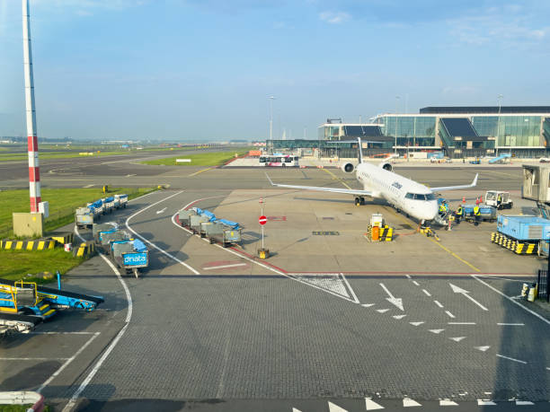 Schiphol, Netherlands-May, 2024: Airfield with airliner and the landing field