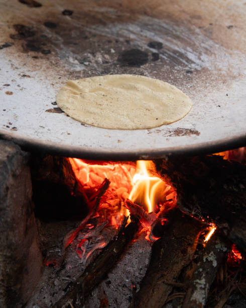 istock Cooking handmade corn tortillas on a traditional comal in an open fire kitchen in Oaxaca Mexico. 2199764755