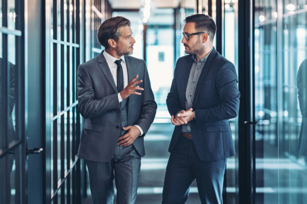 istock Businessmen talking in the corridor 2199765345