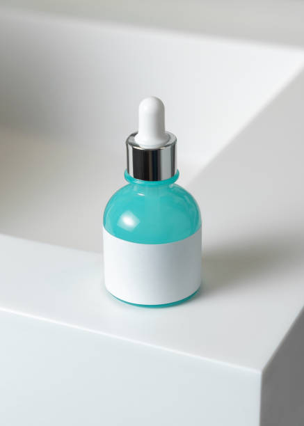 istock Dropper bottle with blank label on white basin close up, packaging mockup.  Natural serum or essence 2199772643