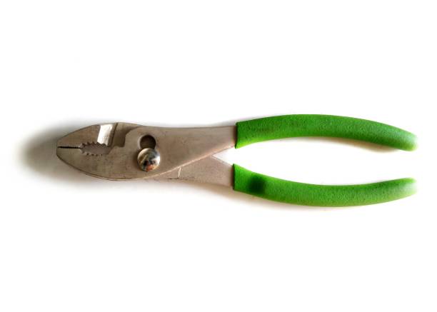 A pair of metal pliers with green handles displayed isolated against a white background. Ideal for themes including tools, repair, DIY, or construction. Suitable for informational or illustrative purposes.