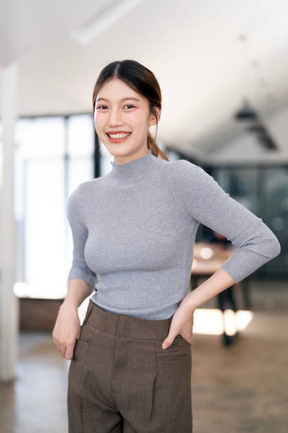istock Smiling creative business woman standing in studio 2199775029