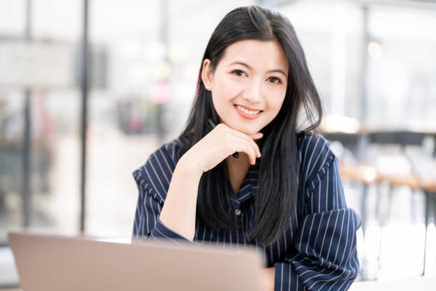 istock Young beautiful joyful woman smiling while working with laptop 2199776103