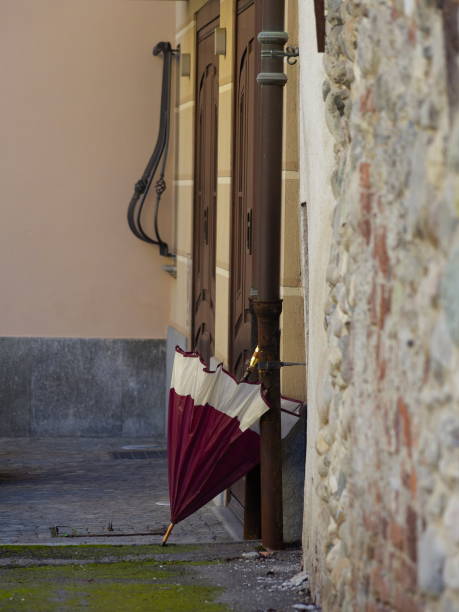 istock Two-tone umbrella, closed, leaning against the wall 2199780608