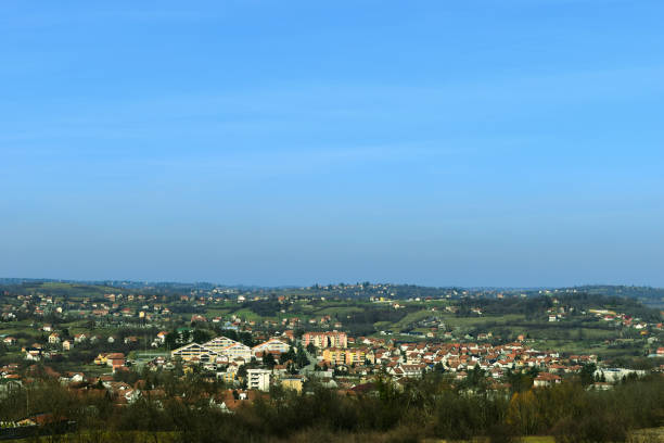 A scenic countryside Sopot town with red-roofed houses, green hills, and a clear blue sky. The landscape captures the charm of rural living and peaceful nature in a panoramic view.