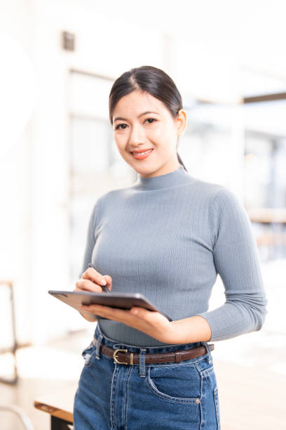 istock Confident woman holding digital tablet standing in her office. 2199782352