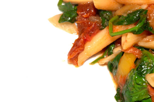 Full frame of multicoloured pasta. Raw uncooked three colored penne pasta.