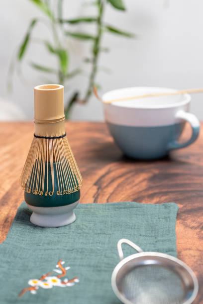 istock Preparing matcha tea with bamboo whisk, strainer and cup 2199783474