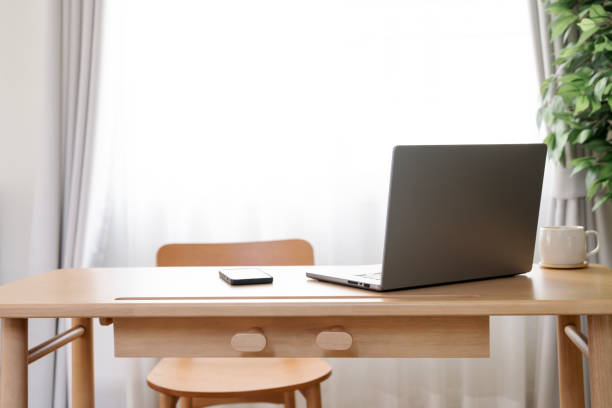 istock Laptop with blank white screen on wooden desk, home office, work from home. 2199783797