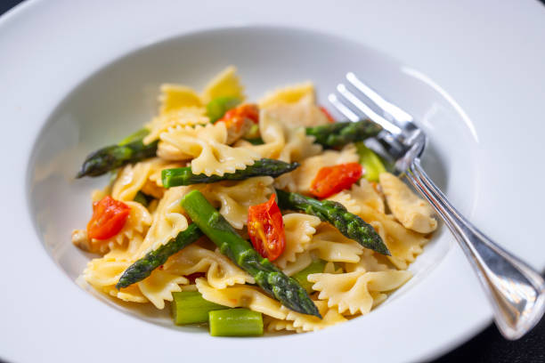 istock Farfalle pasta with green asparagus, cherry tomatoes and chicken 2199786631