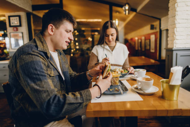 istock Happy young couple visiting local coffee shop 2199792364