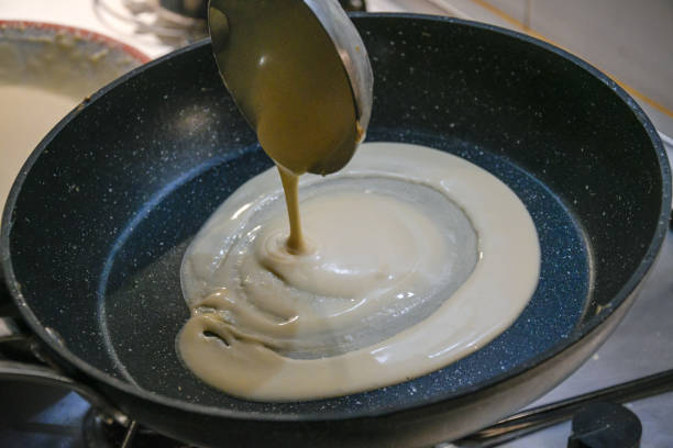 istock Pouring Crepe Batter into a Pan with a Metal Ladle 2199793575