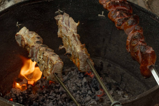 istock traditional gaucho barbecue, made over a fire with the meat on a skewer 2199797761