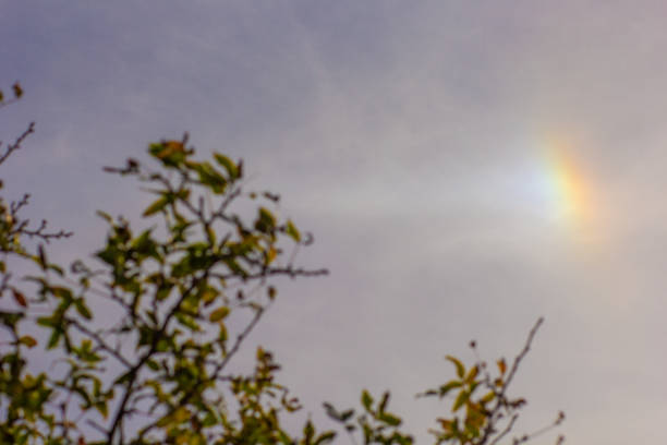 Little part of rainbow on blue sky