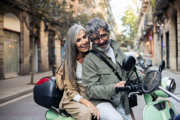 istock Mature couple on an exciting vacation riding a motor scooter 2199802474