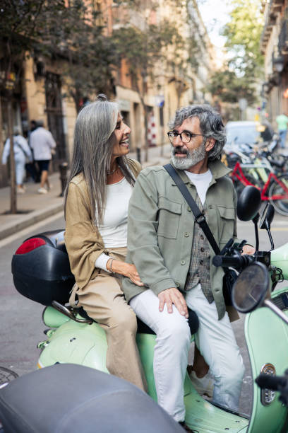 istock Mature couple on vacation having fun riding on a motor scooter 2199802475