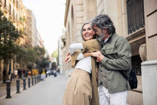 istock Happy mature couple on vacation having fun dancing while walking through the city 2199802480