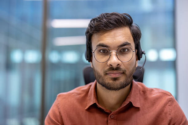 istock Professional hispanic business man wearing headset in modern office environment 2199803542
