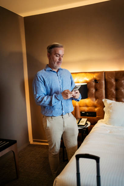 istock Businessman in hotel room 2199807535