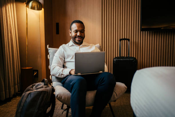 istock Businessman working in hotel room 2199807559
