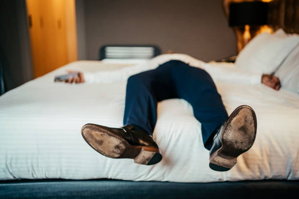 istock Businessman resting in hotel room 2199807625