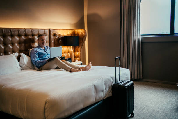 istock Businessman working in hotel room 2199807652