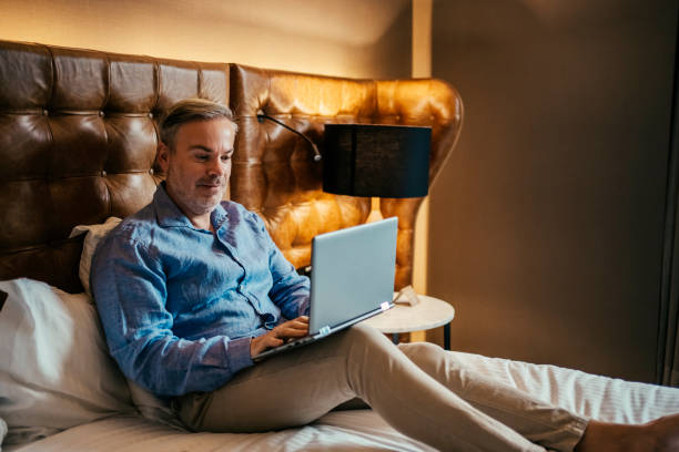 istock Businessman working in hotel room 2199807658
