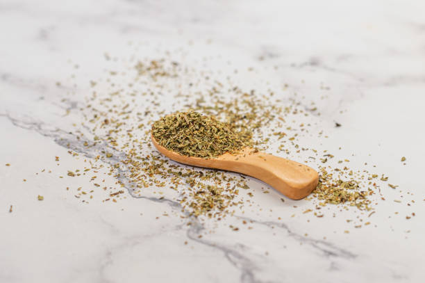 istock Dried herbs on wooden spoon and marble surface 2199808690