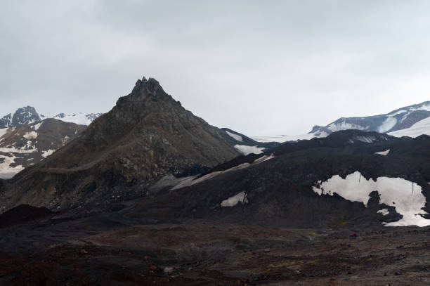 istock mountain range with snow, volcanic desert soil around. mystical mountain landscape 2199809345