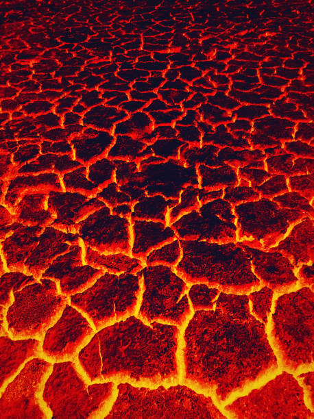 istock Heat red cracked ground texture burning after eruption volcano. Molten active lava texture background. Armageddon natural disaster or hell concept. 2199813773