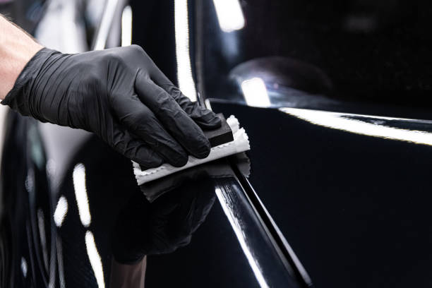 istock Car wash or detailing studio employee applies ceramic or graphene coating 2199814433