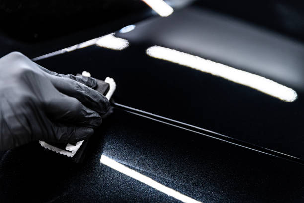 istock Car wash or detailing studio employee applies ceramic or graphene coating 2199814452