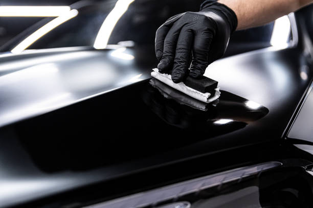 istock Car wash or detailing studio employee applies ceramic or graphene coating 2199814477