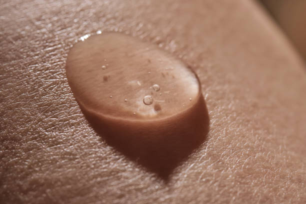 istock Body fluid or cosmetic gel on human skin. 2199814582