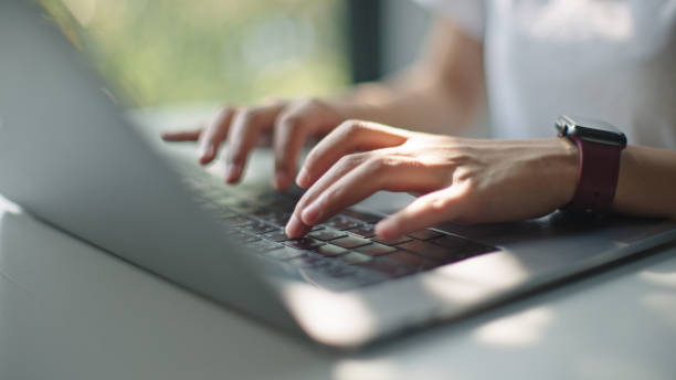 istock Teenager using laptop while wearing headphones. 2199815041