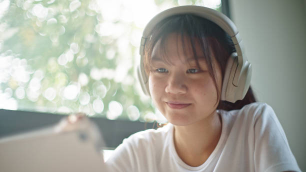 istock Teenage girl using digital tablet. 2199816885