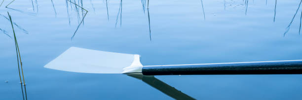 Young Woman Canoeing on The Lake