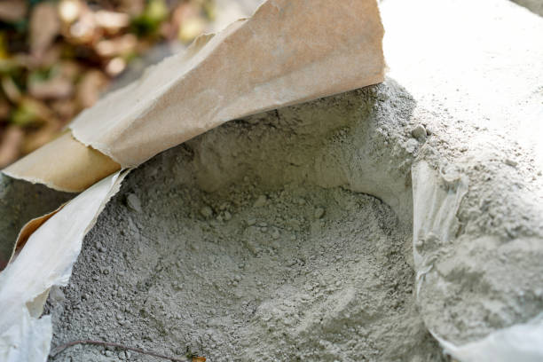 istock Cement powder in brown paper bag package on construction site. Close up. 2199824054
