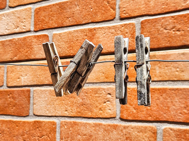 wooden clothing fasteners on empty clothesline.