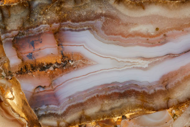 Agate macro detail. close-up of a textured semi-precious gemstone background. backlight transparency
