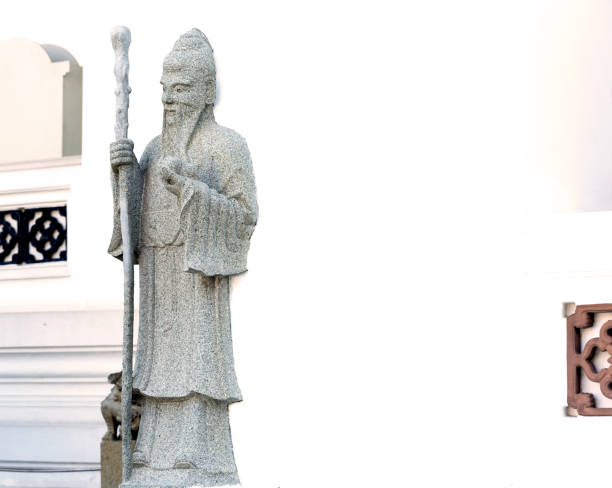 istock wise man with long beard holding his stick and a fruit 2199835696