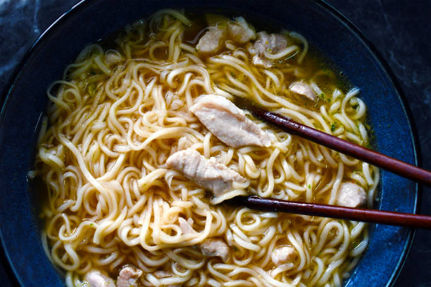 istock Noodles soup with pork and chopsticks. 2199839347