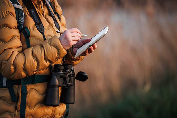 Biologist documents bird watching experiences for study of biodiversity and environmental conservation