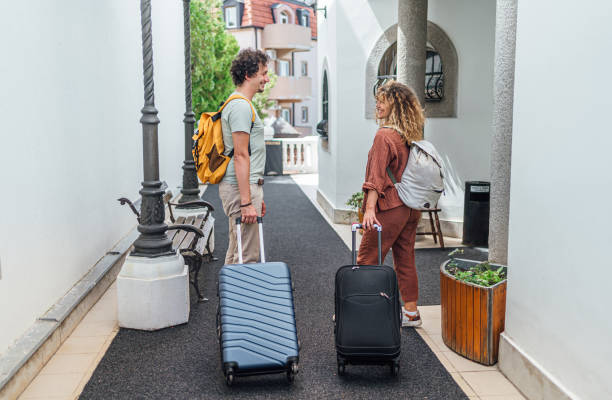 istock Couple with suitcases leaving the hotel 2199841594
