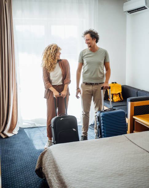 istock Happy couple arriving at a hotel room 2199842451
