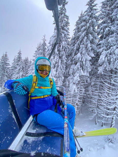 istock Skier on Lift in Snowy Forest 2199843897